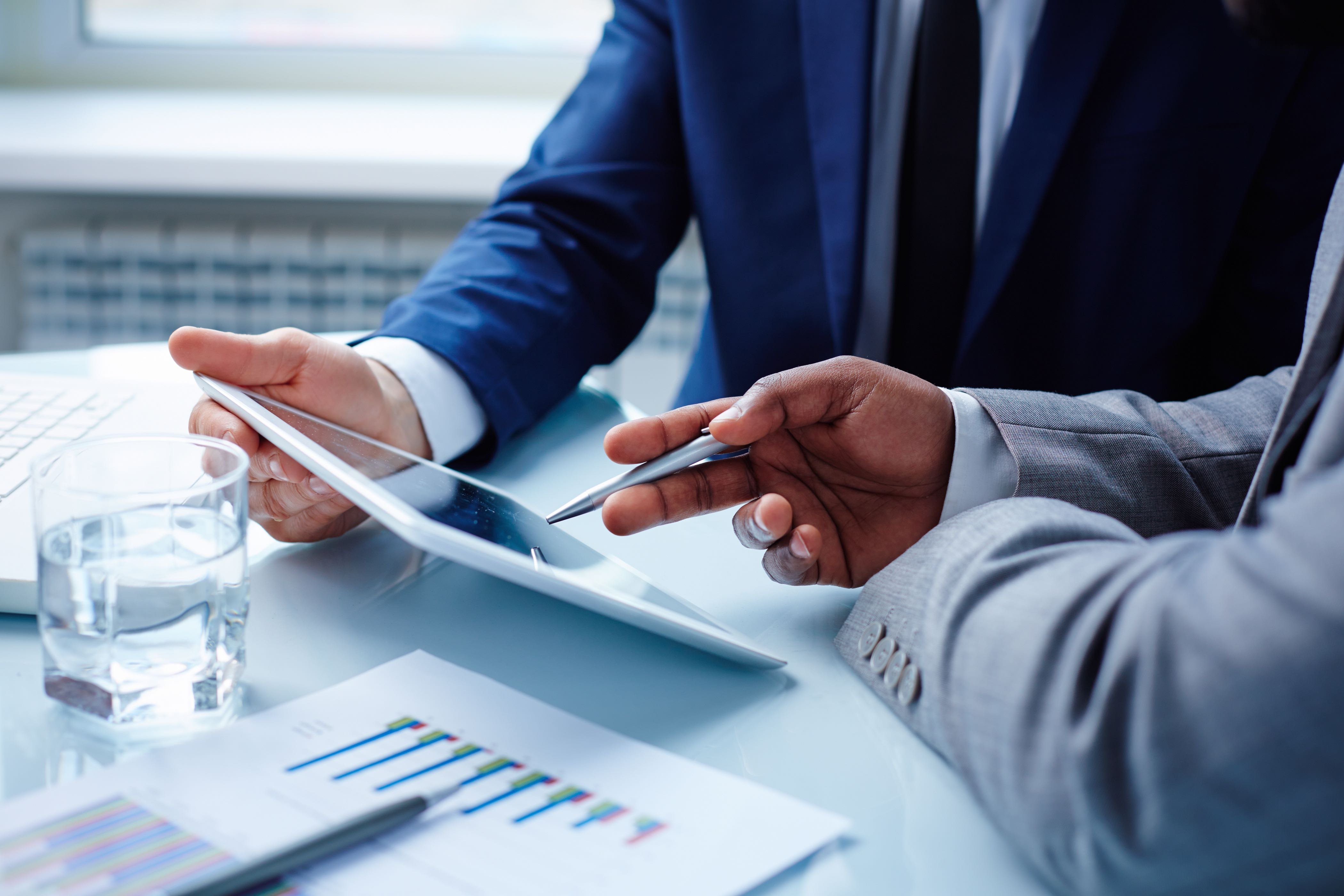 Pointing at tablet during consulting meeting