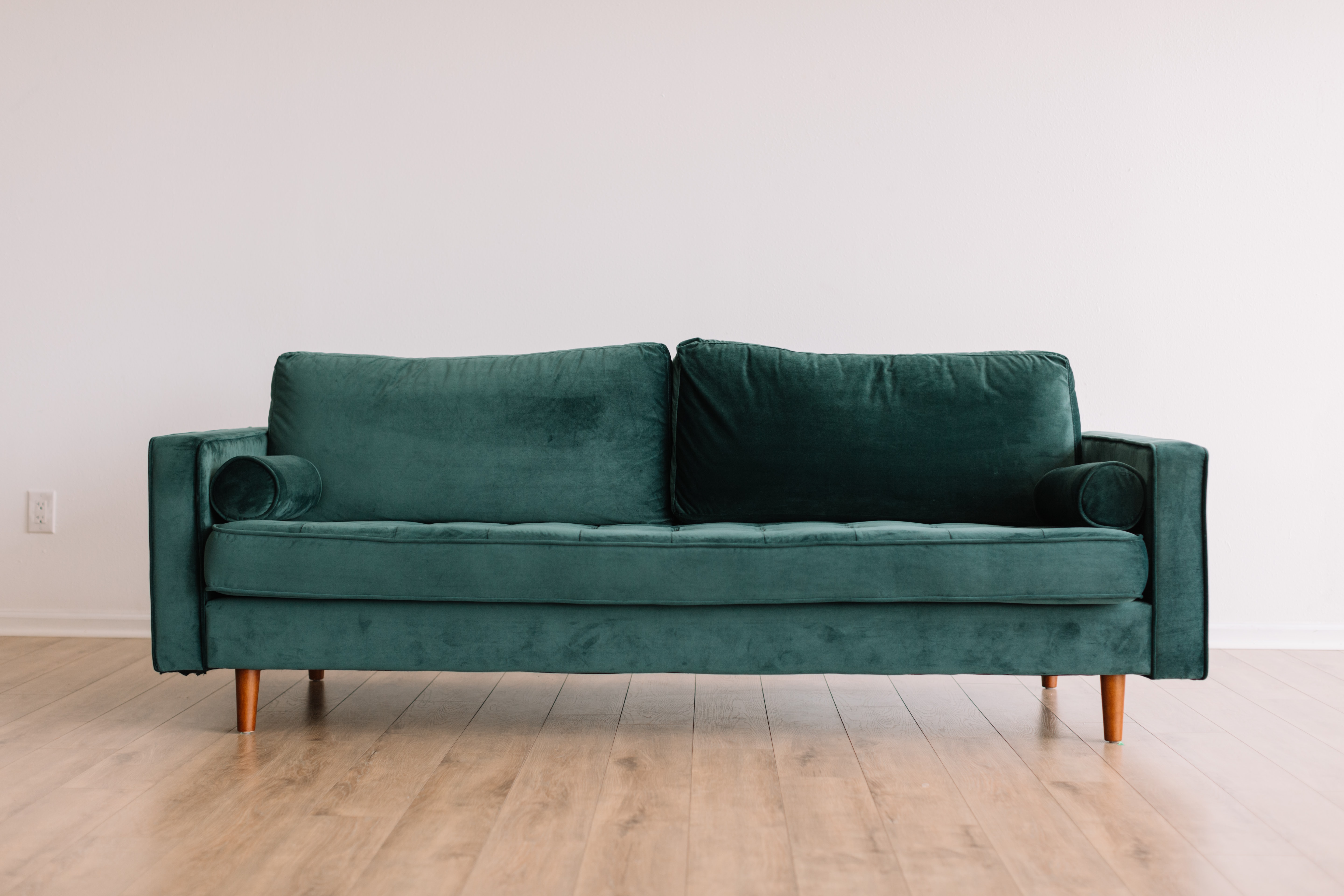 A stock photo of a green velvet couch